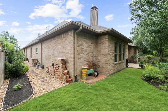 rear view of house featuring a yard