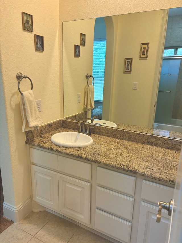 bathroom featuring tile patterned flooring and vanity