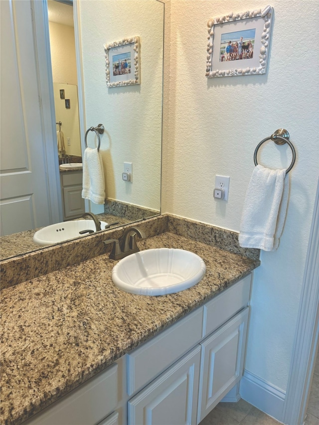 bathroom featuring tile patterned flooring and vanity