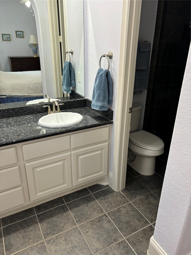 bathroom with tile patterned floors, vanity, and toilet