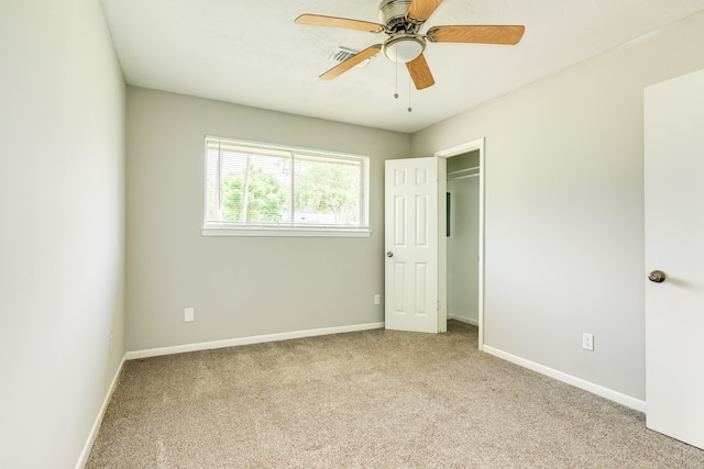 unfurnished bedroom featuring ceiling fan and light carpet