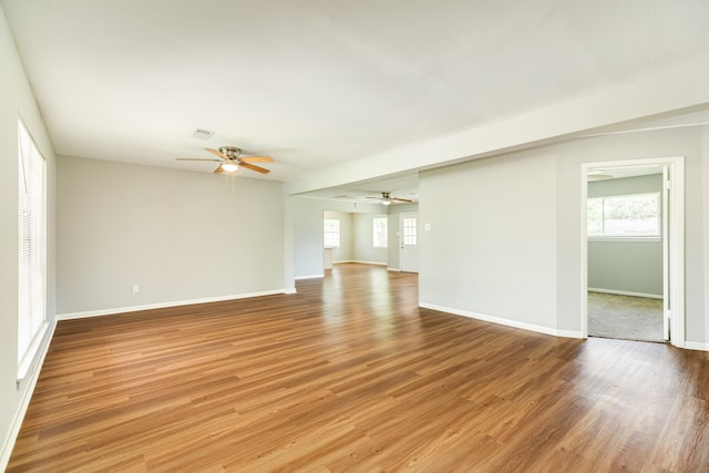 unfurnished living room with ceiling fan and hardwood / wood-style floors