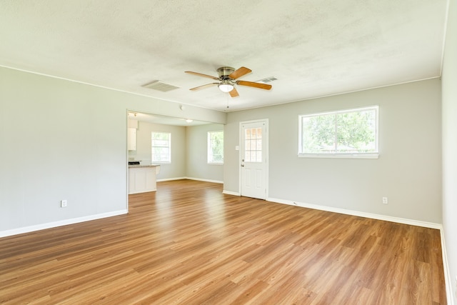 interior space with ceiling fan, light hardwood / wood-style flooring, and a healthy amount of sunlight