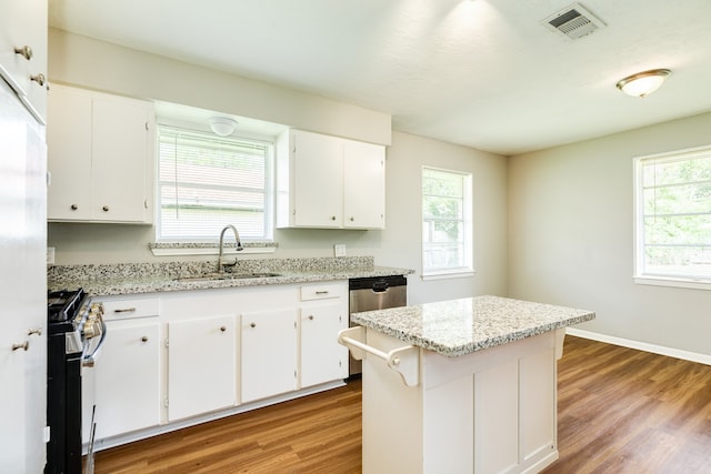 kitchen with plenty of natural light, range, and light hardwood / wood-style flooring