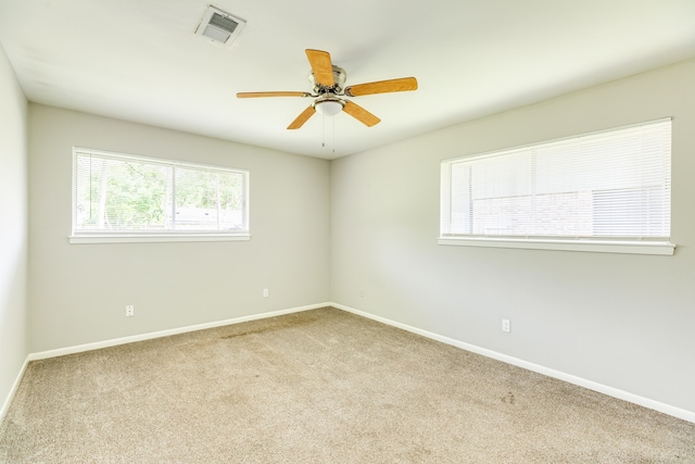 unfurnished room with ceiling fan and light colored carpet