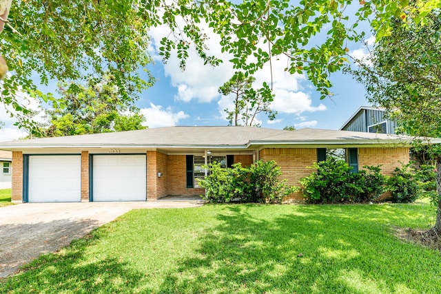 ranch-style home featuring a garage and a front yard