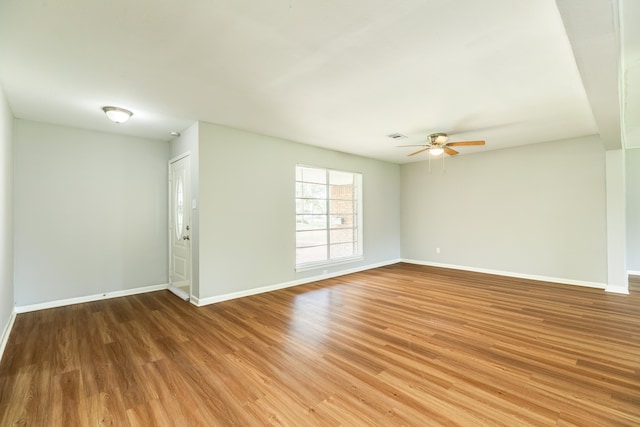 empty room with ceiling fan and wood-type flooring