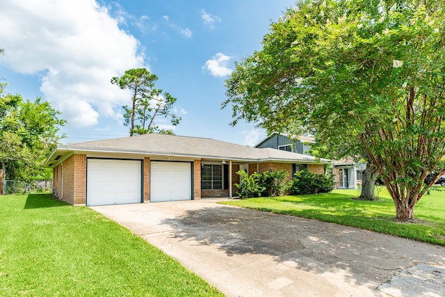 single story home with a front yard and a garage