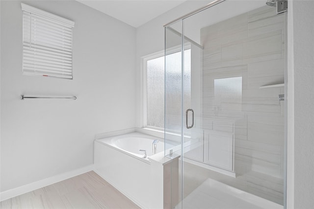 bathroom featuring shower with separate bathtub