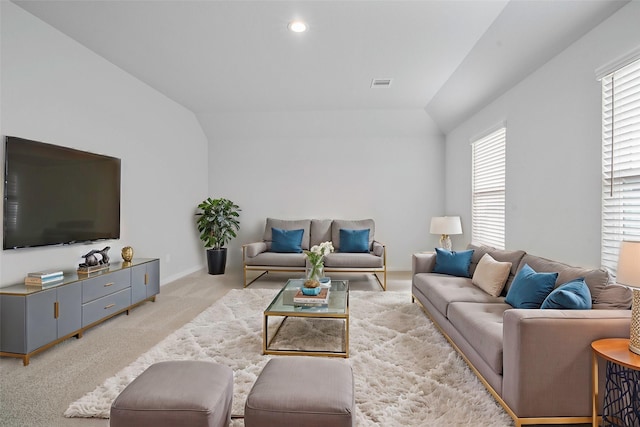 living room with light carpet and vaulted ceiling