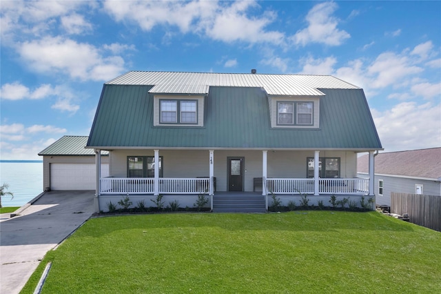 view of front of home with a garage, a porch, and a front yard