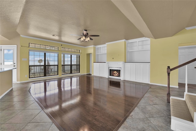 living room featuring ceiling fan, a textured ceiling, light hardwood / wood-style flooring, and crown molding