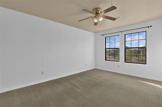 carpeted spare room with ceiling fan