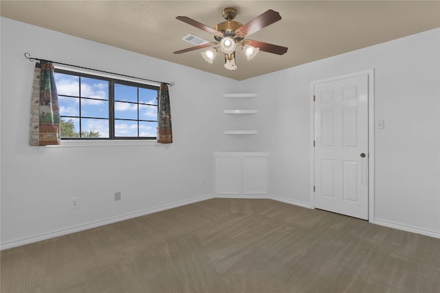 spare room featuring ceiling fan and carpet