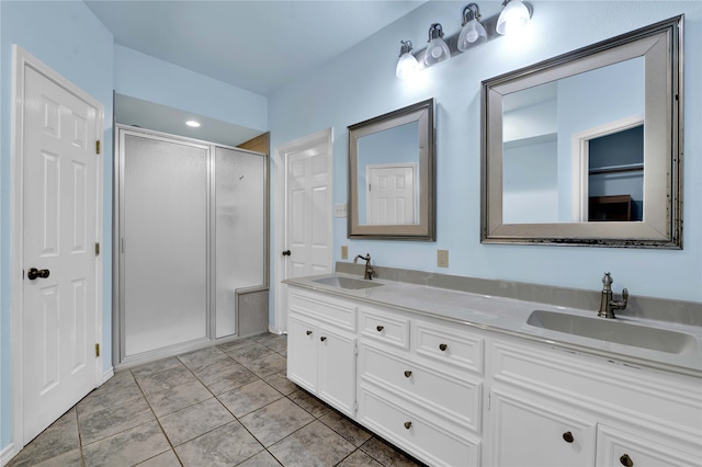 bathroom with tile patterned flooring, vanity, and a shower with shower door