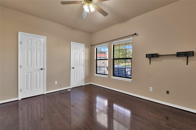 interior space with ceiling fan and dark hardwood / wood-style floors