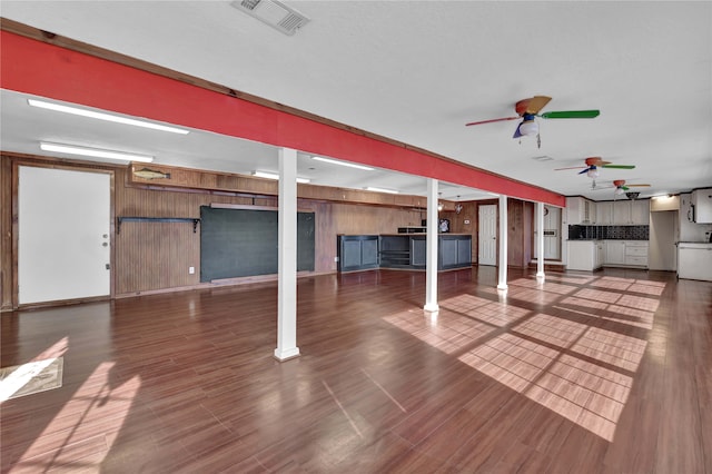 basement featuring ceiling fan and wood-type flooring