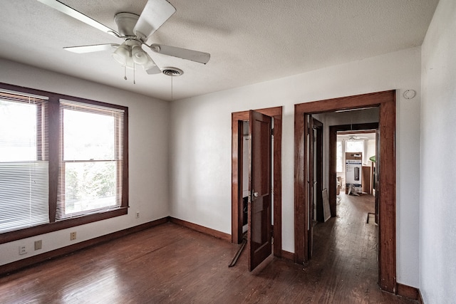 spare room featuring ceiling fan, a textured ceiling, and dark hardwood / wood-style flooring