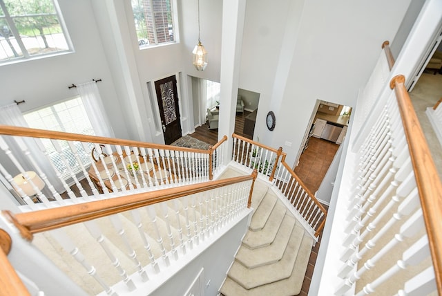 stairs featuring a towering ceiling