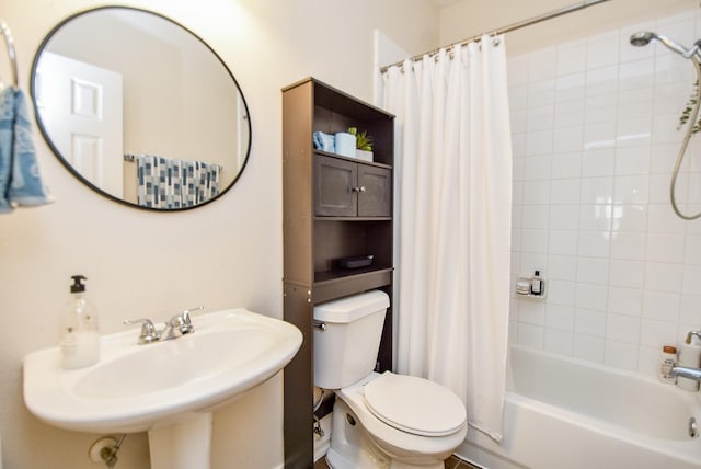 full bathroom with shower / bath combo with shower curtain, a sink, and toilet