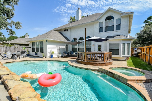 view of pool featuring a patio area, a fenced backyard, a pool with connected hot tub, and a deck