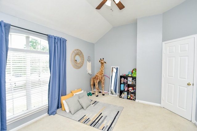 carpeted bedroom featuring a ceiling fan, vaulted ceiling, and baseboards