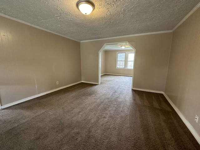 empty room with ornamental molding, a textured ceiling, and carpet flooring