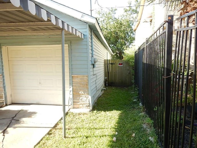 garage featuring wood walls and a lawn