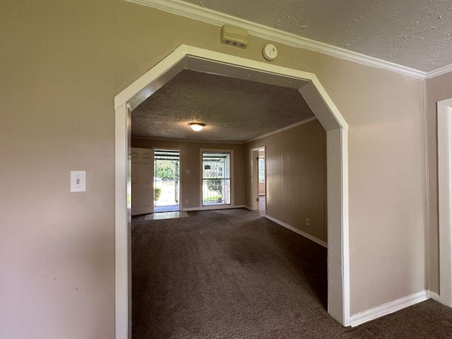 interior space featuring ornamental molding and a textured ceiling