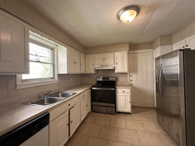 kitchen featuring light tile patterned floors, stainless steel appliances, white cabinetry, sink, and a textured ceiling