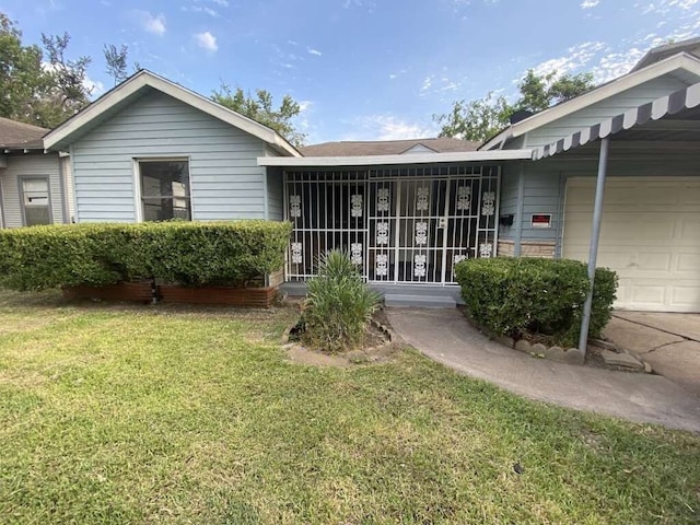 view of front of property with a garage, a sunroom, and a front lawn