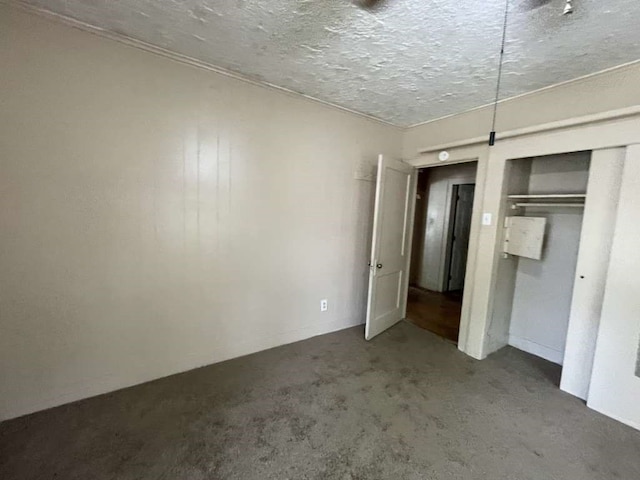 unfurnished bedroom featuring a closet, a textured ceiling, and carpet floors