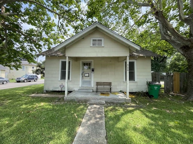 bungalow-style house with a front yard