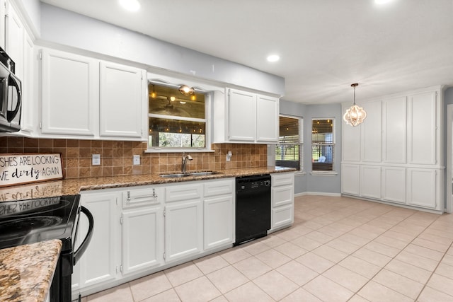 kitchen with hanging light fixtures, stone countertops, white cabinets, a sink, and black appliances