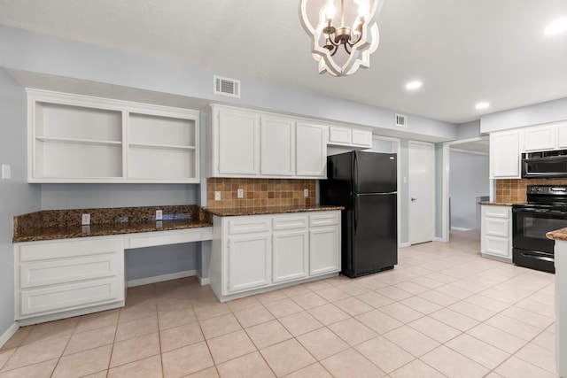 kitchen featuring black appliances, built in study area, visible vents, and white cabinets