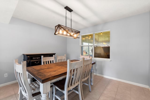 dining space with baseboards and light tile patterned flooring