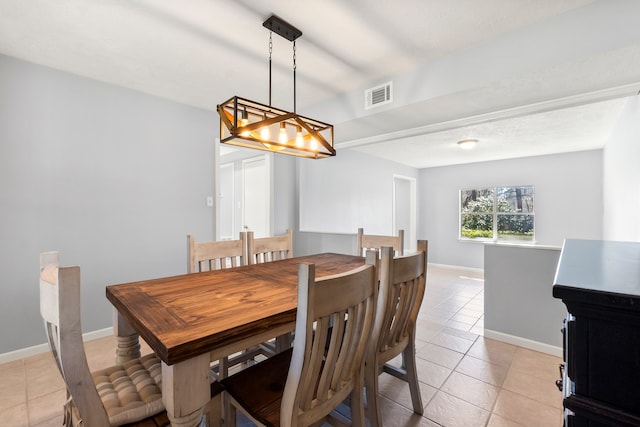 dining area featuring an inviting chandelier, visible vents, baseboards, and light tile patterned floors