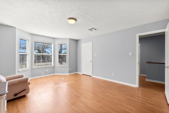 interior space featuring a textured ceiling and light wood-type flooring