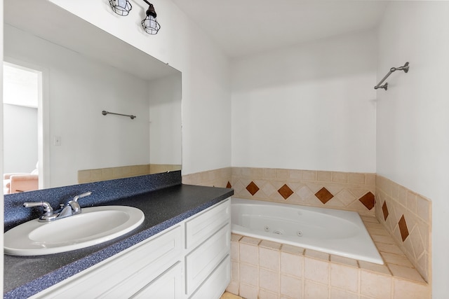 full bathroom with a tub with jets and vanity