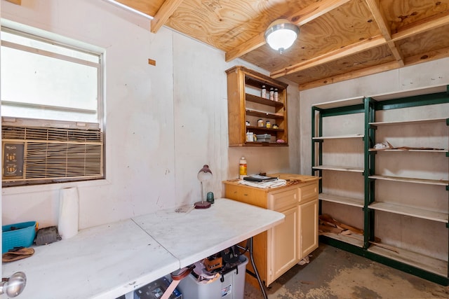 interior space featuring unfinished concrete floors, cooling unit, light countertops, and open shelves