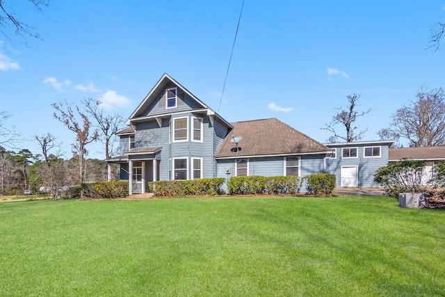 rear view of house with a yard