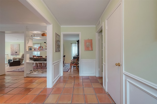 hall featuring light tile patterned flooring and ornamental molding