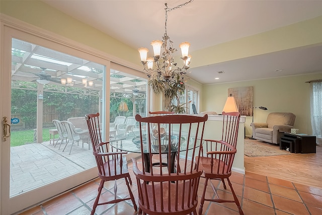 dining space featuring light wood-type flooring and a notable chandelier