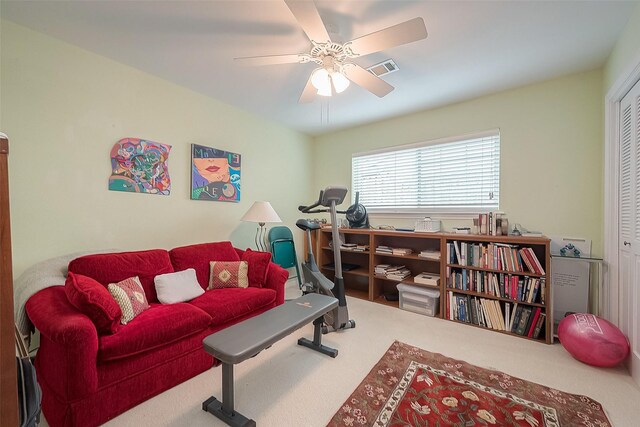 carpeted living room with ceiling fan