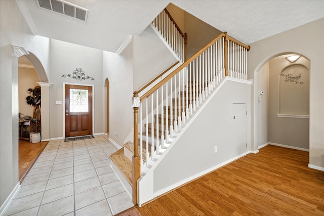 entrance foyer with light hardwood / wood-style floors and a textured ceiling