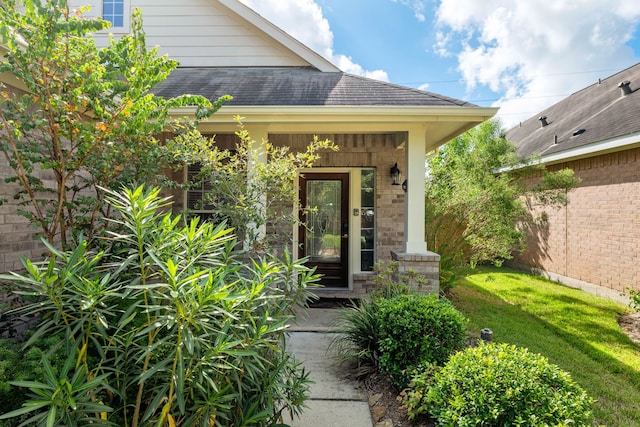 doorway to property with a yard