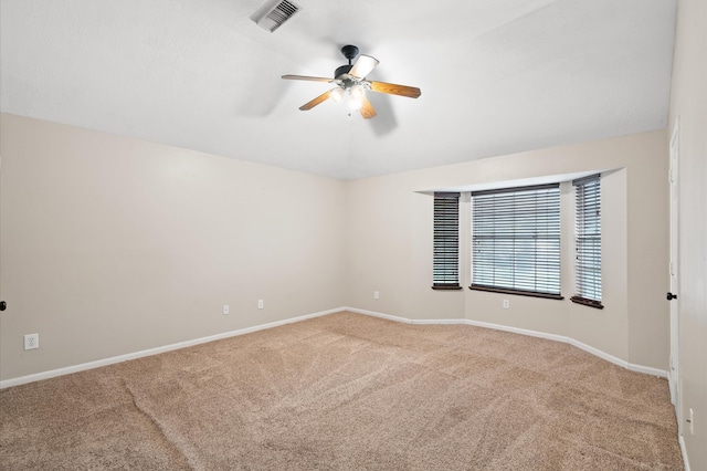 unfurnished room with ceiling fan and light colored carpet