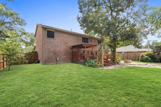 back of house with a deck and a lawn