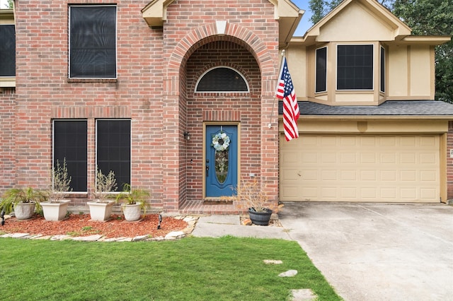 view of front of property featuring a garage and a front lawn