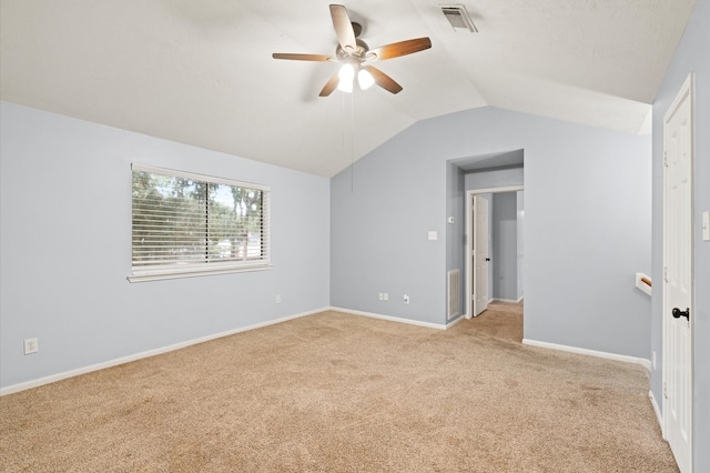 carpeted empty room featuring ceiling fan and lofted ceiling